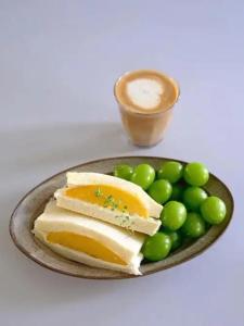 a plate of food with cheese and green grapes at M Panda Tower Boutique Chengdu in Chengdu +72 photos