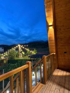 a deck with a view at night at Azalea 1, Cozy Wooden Villa in Tirana