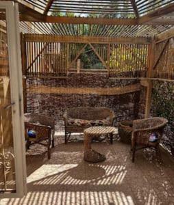 acovered patio with chairs and a table and a bench at 1038 · 2BR TownhouseBath TV Backyard in Sheikh Zayed