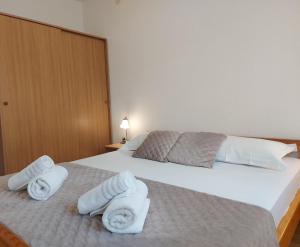 a hotel room with two beds with towels on them at Apartments Gojevic in Bol