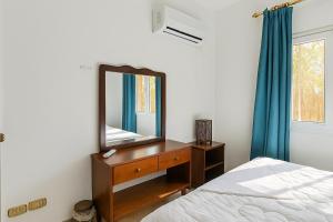 a bedroom with a mirror on a dresser and a bed at 1038 · 2BR TownhouseBath TV Backyard in Sheikh Zayed