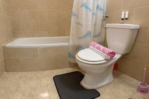 a bathroom with a toilet and a shower curtain at 1038 · 2BR TownhouseBath TV Backyard in Sheikh Zayed +11 photos