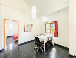 a dining room with a table and a bedroom at The Endless Bangtao Residence Chat 1 in Bang Tao Beach +9 photos