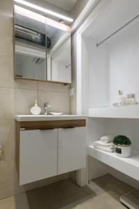 a bathroom with a sink and a mirror at Liston Suites Anastasia in Corfu Town