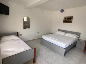 Postel nebo postele na pokoji v ubytování Guest House Vlore