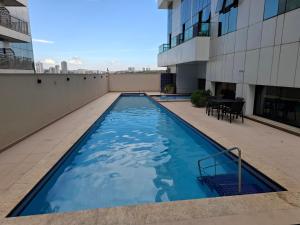 a swimming pool on the roof of a building at Conjunto Estúdio e Duplex Selenita by Rhouses in Barueri