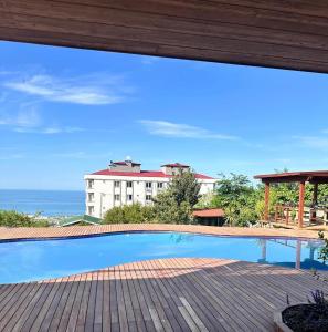 a swimming pool with a view of a building at Trabzon House - Pool, Sea View & Nature in Bostancı