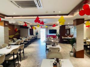 a restaurant with tables and chairs and balloons on the ceilings at Hotel Banaras Villa in Kakarmatha +29 photos
