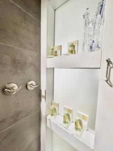 a bathroom with white shelves and a shower at Del Mar 2 Deluxe Apartment Playa del Cura Torrevieja in Torrevieja