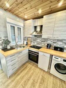 a kitchen with a sink dishwasher and a stove at Del Mar 2 Deluxe Apartment Playa del Cura Torrevieja in Torrevieja
