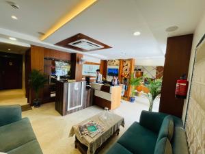 a lobby with couches and a table and a counter at Hotel Banaras Villa in Kakarmatha