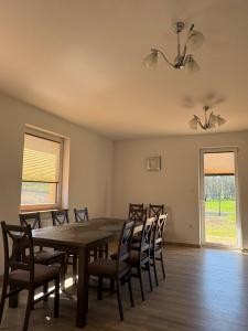 a dining room with a table and chairs at Agroturystyka Żółta Ostoja in Lipowo