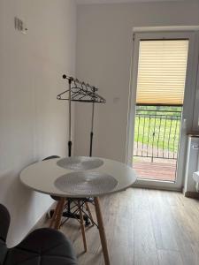 a table and chairs in a room with a window at Agroturystyka Żółta Ostoja in Lipowo +30 photos