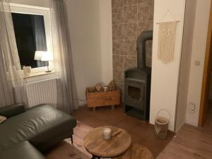 a living room with a couch and a wood stove at Urlaubshaus-Braunlage Wohnung 2 in Braunlage