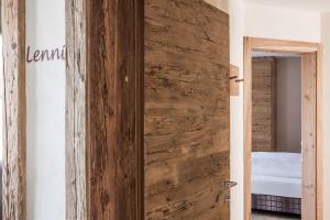 a wooden door in a room with a bedroom at Osti Nicl in San Martino in Badia