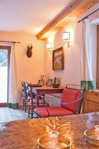 a dining room with a table and chairs at Chalet Gulas - La Punt-Chamues-ch in La Punt-Chamues-ch