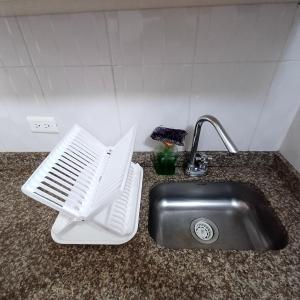 blat kuchenny ze zlewem i białą płytą grzejną w obiekcie Apartamento Muy Central w mieście Manizales +7 zdjęć