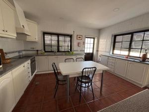 a kitchen with a white table and chairs at Casa Sampaio e Melo in Gafanha da Nazaré