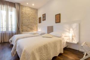 Posteľ alebo postele v izbe v ubytovaní Pellegrini Luxury Rooms