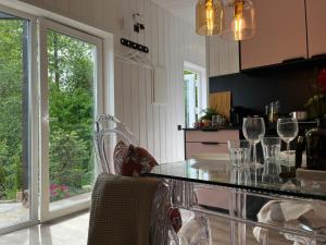 a kitchen with a counter with wine glasses on it at Garden Residence - The Lotus in Drahobudice