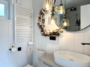 a white bathroom with a sink and a mirror at Garden Residence - The Lotus in Drahobudice +61 photos