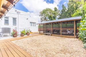 a backyard with a wooden deck with a pavilion at Splendid Mediterranean Retreat Gorgeous Outdoor in North Miami