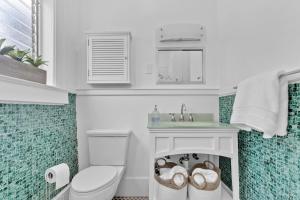 a white bathroom with a toilet and a sink at Splendid Mediterranean Retreat Gorgeous Outdoor in North Miami +39 photos