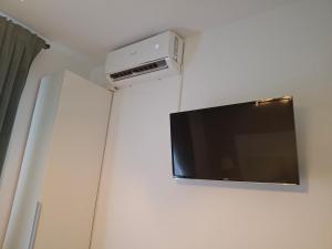 a flat screen tv hanging on a wall at Clar Studio Residence in Braşov