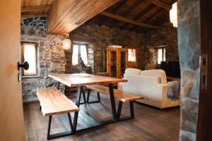 a living room with a table and a couch at Casa dos Desenhos in Lousã
