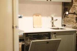 a kitchen with a sink and a dishwasher at Casa dos Desenhos in Lousã +20 photos