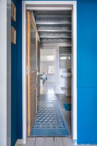 Panorama vue mer et plein centre ville في لاسيوتا: باب يؤدي إلى حمام ذو جدار أزرق