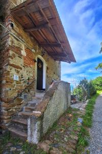 a brick building with stairs leading to a door at Ca' Vegia in Casaleggio Boiro