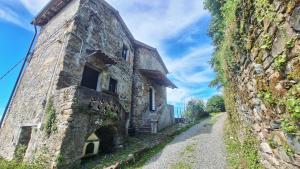 an old stone building on the side of a mountain at Ca' Vegia in Casaleggio Boiro
