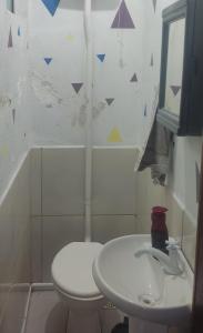 a bathroom with a toilet and a sink at Casa Lagoa Santo Antônio in Laguna +6 photos