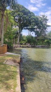 a body of water with trees in the background at Casa Lagoa Santo Antônio in Laguna