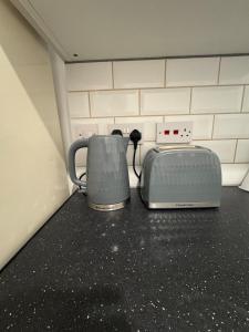 a microwave and a toaster sitting on a counter at 29 Sweet 1 Bed sleeps 4 with free parking BHX NEC in Sheldon