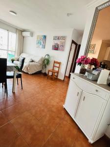 a living room with a couch and a table at Beachfront apartment DIANA 2 in Benalmádena