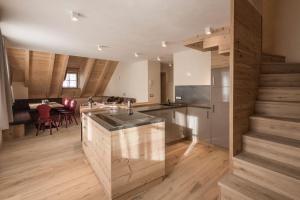 a kitchen with a counter and a dining room at Osti Nicl in San Martino in Badia