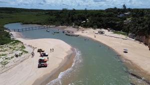 an aerial view of a beach with boats in the water at Casa Jeito Mineiro in Mucuri