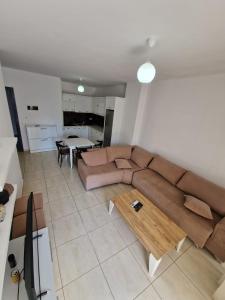 a living room with a brown couch and a table at Summer Apartments in Shengjin in Shëngjin