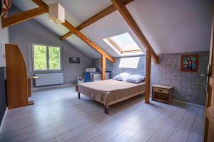 a bedroom with a bed and a skylight at Maison spacieuse au calme in Morcenx +31 photos