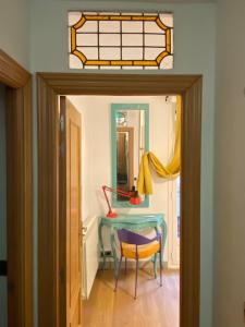a dining room with a table and a stained glass window at kasapereira23 in Logroño