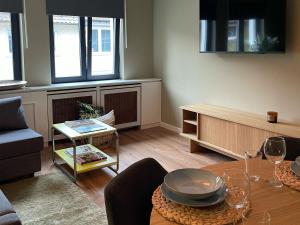 a living room with a table and a couch at Louise Boutique Apartment 3 in Friedrichshafen