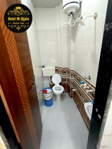 a bathroom with a toilet and a sink at HOTEL IN UJJAIn in Ujjain