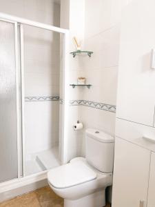 a white bathroom with a toilet and a shower at I Loft 9 I Centro de Alcala Sevilla in Alcalá de Guadaira +21 photos