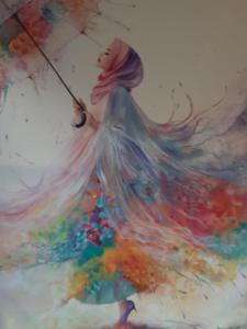 een schilderij van een vrouw met een paraplu bij Ioni Home in Tsagarada