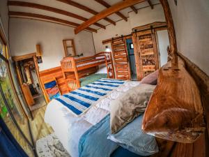 a bedroom with a bed with a wooden frame at Cabañas Sendero del Zorro in Chillán