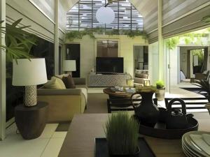 a living room with a couch and a table at Kawung Villa Canggu in Canggu