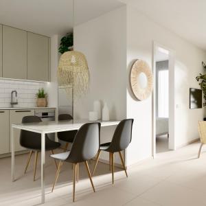 a white kitchen with a dining table and chairs at Valencia Living Suites in Picanya