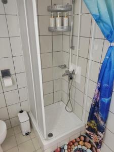 a shower in a bathroom with a shower curtain at Korina in Ofrínion +50 photos